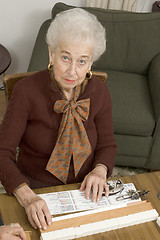 Image showing senior woman at the game table