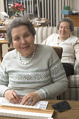 Image showing senior woman at the game table