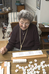 Image showing senior woman at the game table