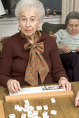 Image showing senior woman at the game table