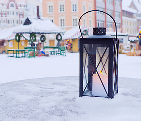 Image showing Lantern on a table on a background of the Christmas market