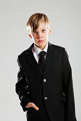 Image showing Serious young boy in black suit