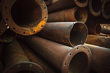 Image showing Rusty old pipes stacked up