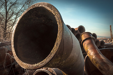 Image showing Rusty old pipes stacked up