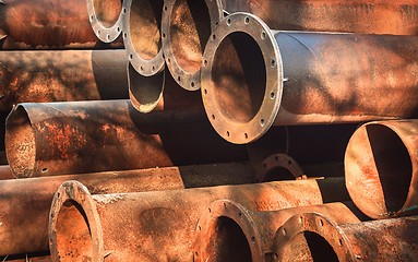 Image showing Rusty old pipes stacked up