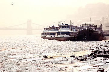 Image showing Big boats stuck in the ice at winter