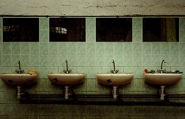 Image showing An abandoned industrial interior with a depressed man