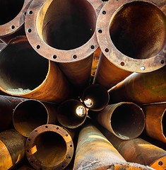 Image showing Rusty old pipes stacked up