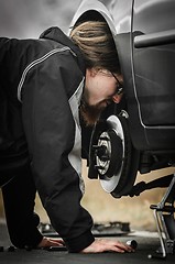 Image showing Young man in the middle of a car repair