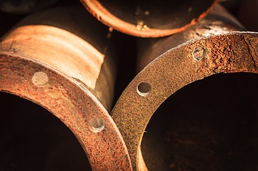 Image showing Rusty old pipes stacked up