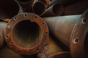 Image showing Rusty old pipes stacked up