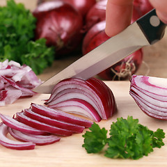 Image showing Preparing food: cutting a red onion