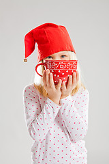 Image showing Smiling young girl holding big red cup