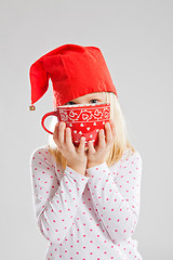 Image showing Smiling young girl holding big red cup