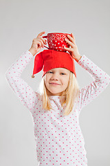 Image showing Happy young girl holding big cup on head