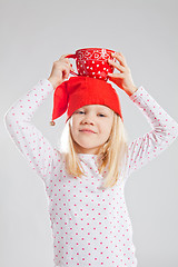 Image showing Happy young girl holding big cup on head