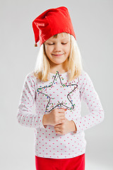 Image showing Happy young girl holding Christmas star decoration