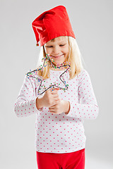 Image showing Happy young girl holding Christmas star decoration