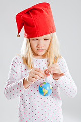 Image showing Young girl holding world in hands