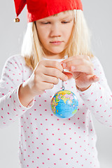 Image showing Young girl holding world in hands