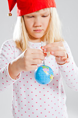 Image showing Young girl holding world in hands