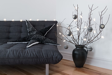 Image showing Gray sofa, winter decorations and cozy lights