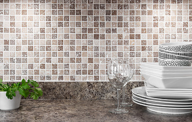 Image showing Dishware and green herbs on kitchen countertop