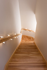 Image showing Wooden staircase decorated with lights