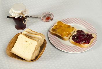 Image showing Spread jam on bread