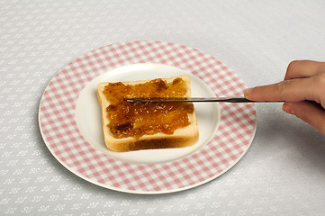 Image showing Spread jam on bread