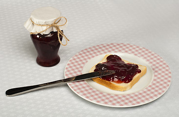 Image showing Spread jam on bread