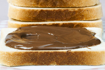 Image showing Liquid chocolate on a slice of bread