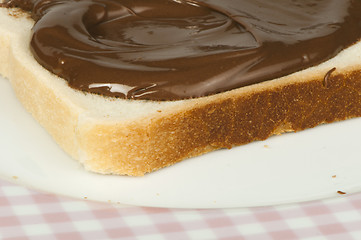 Image showing Liquid chocolate on a slice of bread