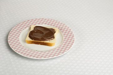 Image showing Liquid chocolate on a slice of bread