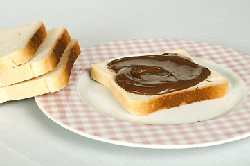 Image showing Liquid chocolate on a slice of bread