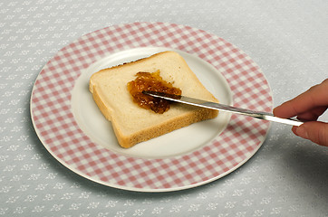 Image showing Spread jam on bread