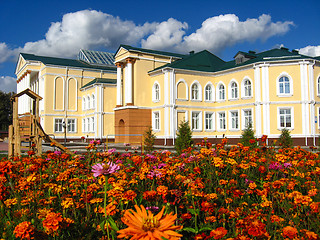 Image showing Beautiful school on a background of flowers