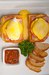 Image showing eggs benedict on bread with tomato and ham