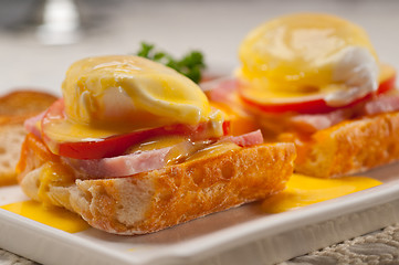 Image showing eggs benedict on bread with tomato and ham