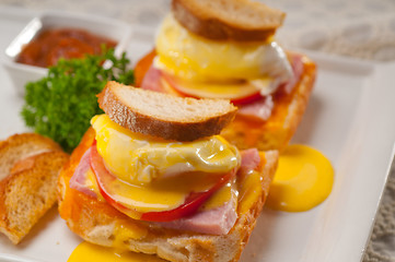 Image showing eggs benedict on bread with tomato and ham