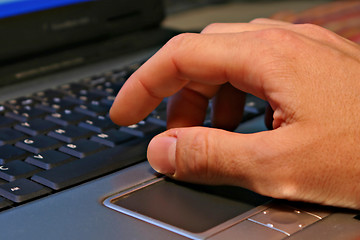 Image showing Hand on notebook keyboard