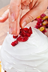 Image showing Hands decorating christmas cake