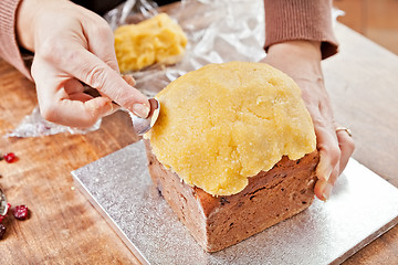 Image showing Decorating christmas cake with spoon