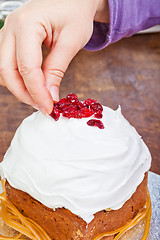 Image showing Hands decorating christmas cake