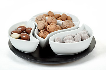 Image showing almonds in chocolate and walnuts on white