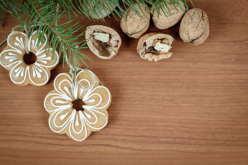 Image showing walnuts and gingerbread on wooden background