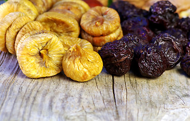 Image showing dried plums and figs in wooden table