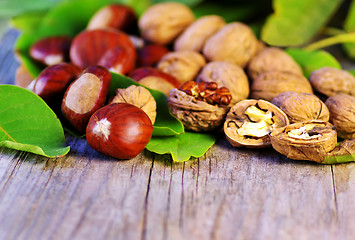 Image showing  chestnuts and walnuts on wooden table