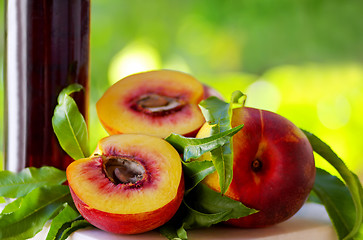 Image showing Peaches and bottle of liquor