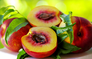 Image showing Sliced peachs on green background